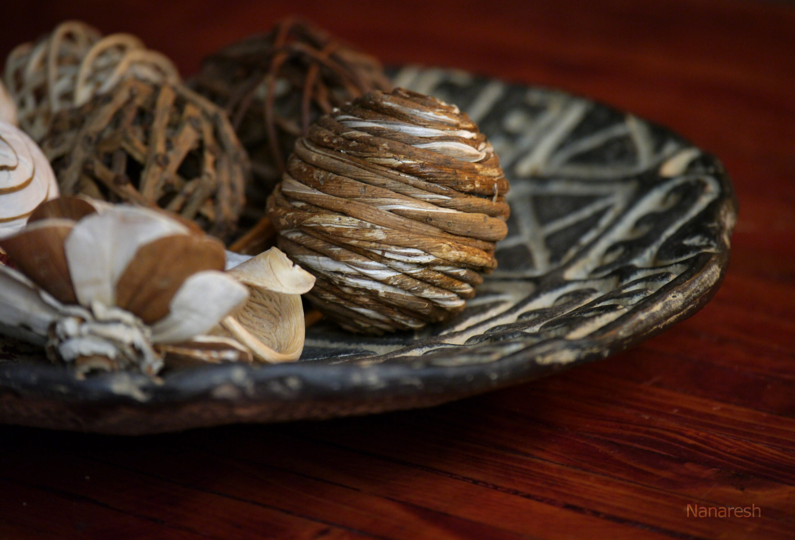 Close-up of a table decor of a plate and balls. Photo by Nanaresh-2024